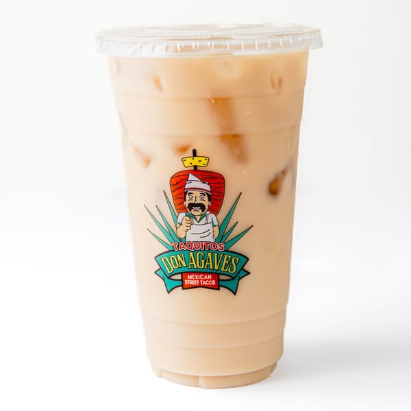 Iced horchata in a clear plastic cup with the Taquitos Don Agaves logo on a white background.
