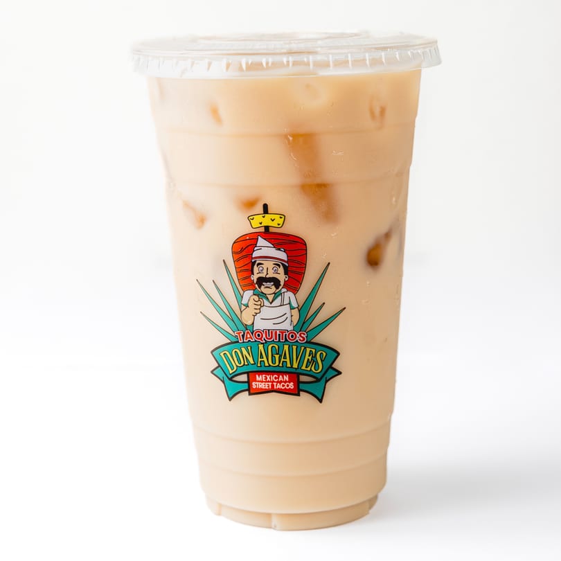Iced horchata in a clear plastic cup with the Taquitos Don Agaves logo on a white background.